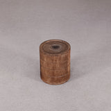 Wooden cylindrical container on a gray background