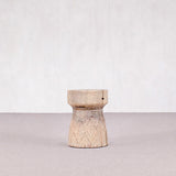 Wooden stool with geometric pattern on a light gray surface and white background