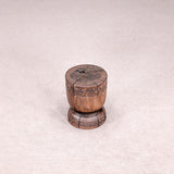 Wooden stool with intricate carvings on a light gray background