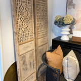 Decorative wooden mats with intricate patterns on a white surface.