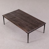 Rectangular wooden table with metal legs on a gray background
