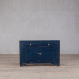 Blue wooden cabinet against a gray wall