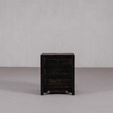 Dark wooden nightstand with two drawers on a gray background