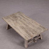 Wooden table with a rustic finish on a gray background
