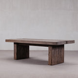 Wooden coffee table with a rustic design on a plain background