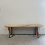 Wooden bench against a plain white wall
