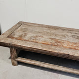 Weathered wooden table against a plain background