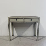 Vintage-style console table with two drawers against a plain wall.