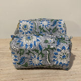 Floral-patterned fabric on a wooden surface with a neutral background