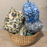 Floral-patterned bags in a woven basket on a wooden surface