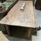 Wooden dining table with chairs in a room setting