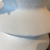 Close-up of a white ceramic vase with a textured surface.