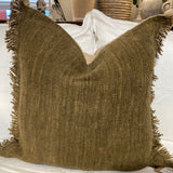 Green textured throw blanket with fringe on a white surface