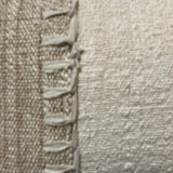 Close-up of a textured fabric with a visible seam.