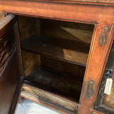 Wooden cabinet with open door showing interior shelves.