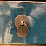Pair of bronze earrings on a reflective surface