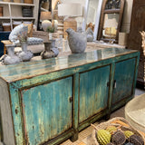 Vintage-style sideboard with distressed finish in a home decor setting