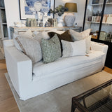 White sofa with decorative pillows in a living room setting