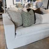 Gray sofa with patterned cushions in a room setting