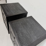 Two matching dark wood nightstands with a distressed black finish, shown from an elevated angle against a plain white wall.