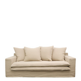 Beige sofa with cushions on a white background