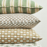 Three patterned pillows stacked on a light background
