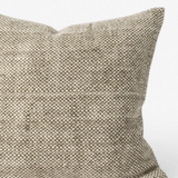 A square throw pillow with a textured, woven heathered fabric in a neutral taupe-beige color, shown against a plain white background.