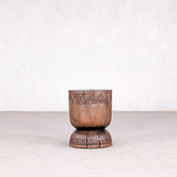 Wooden cup with geometric patterns on a white background