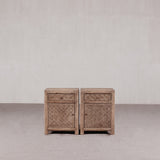 Pair of textured wooden nightstands against a plain background