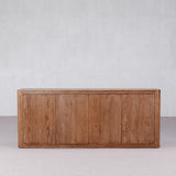 Wooden cabinet with three doors on a plain background
