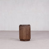 Textured cylindrical vase on a neutral background