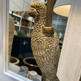 Decorative metal handle shaped like a fish on a mirror