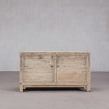 Wooden sideboard with two doors against a plain background