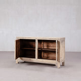 Wooden sideboard with open doors on a plain background