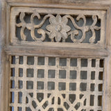 Decorative wooden panel with intricate carvings on a white background