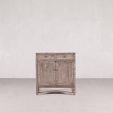 Wooden cabinet with two doors and a drawer on a white background