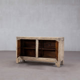 Wooden cabinet with open doors on a plain background