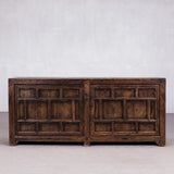 Vintage wooden sideboard against a plain white wall