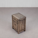 Wooden side table with a rustic finish on a plain background