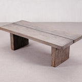 Wooden dining table with a rustic design on a plain background