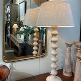 Decorative mirror with ornate frame on a white surface
