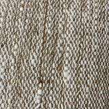 Close-up of a textured beige fabric surface