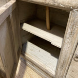 Wooden cabinet with open door showing interior shelves.