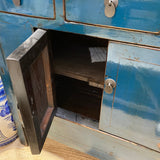 Blue metal cabinet with an open door, showing a dark interior.