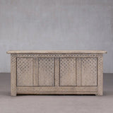Wooden chest with decorative patterns on a plain background