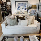 White sofa with decorative pillows in a stylish living room setting.