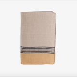 Folded beige towel with a dark stripe on a white background