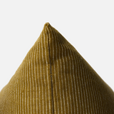 Close-up of a textured woven cushion cover in a mustard yellow color with a fine white dotted stripe pattern, showing the pointed corner against a light gray background.