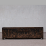 Vintage wooden sideboard against a plain wall